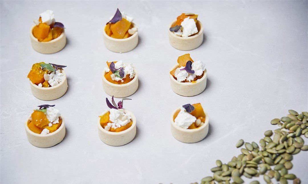 Spiced pumpkin, pine nut, marinated chèvre tartlets (V) (G) (N)