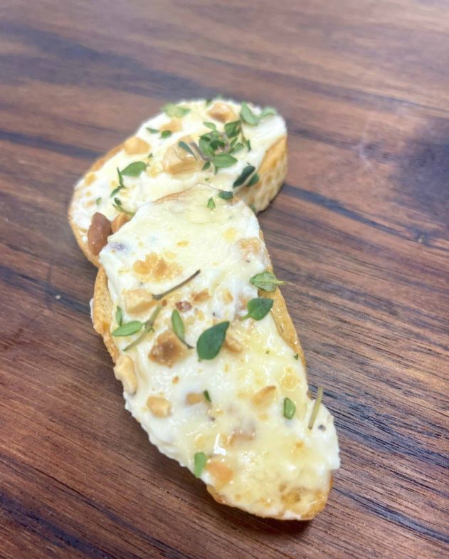 Crisp crostini, creamy goat cheese, toasted hazelnuts, honey, and fresh thyme.