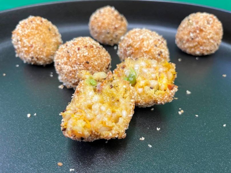 Arancini filled with pumpkin, sun-dried tomato, pea
