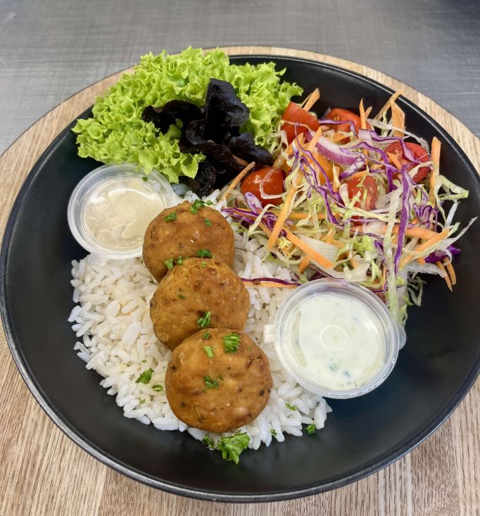 In house  spiced falafel salad bowl, tzatziki, hummus, seasoned rice and seasonal salad 