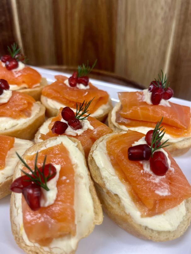 Smoked salmon crostini, whipped lemon cream cheese, pomegranate, dill