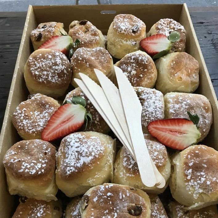 Fresh mini scones served with jam and whipped cream