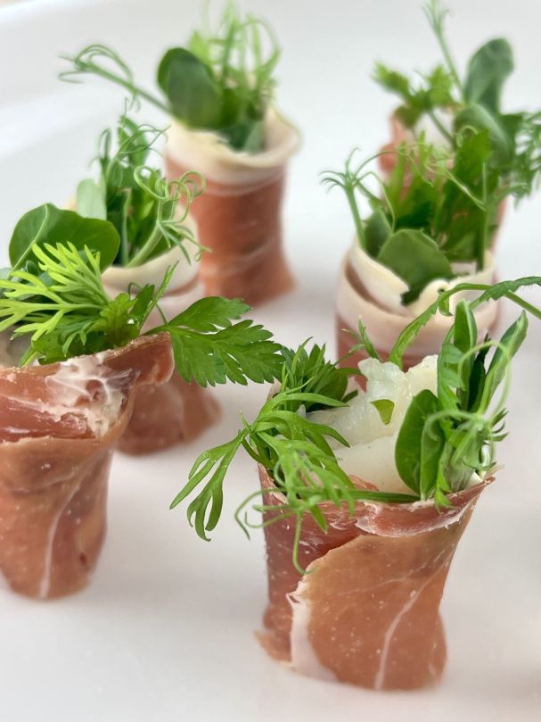 Poached tiger prawn prosciutto, yuzu cream & pea shoots. (NAG)